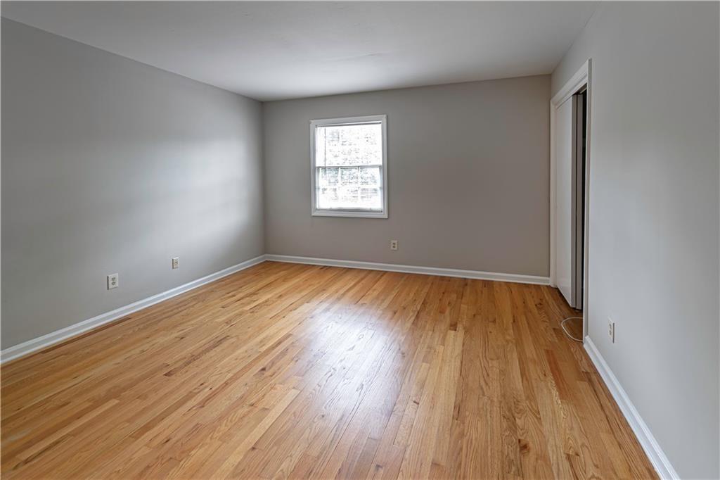 3071 Colonial Way, Unit E Atlanta, GA 30341 - Photo 15 of 16 an empty room with wooden floor and windows