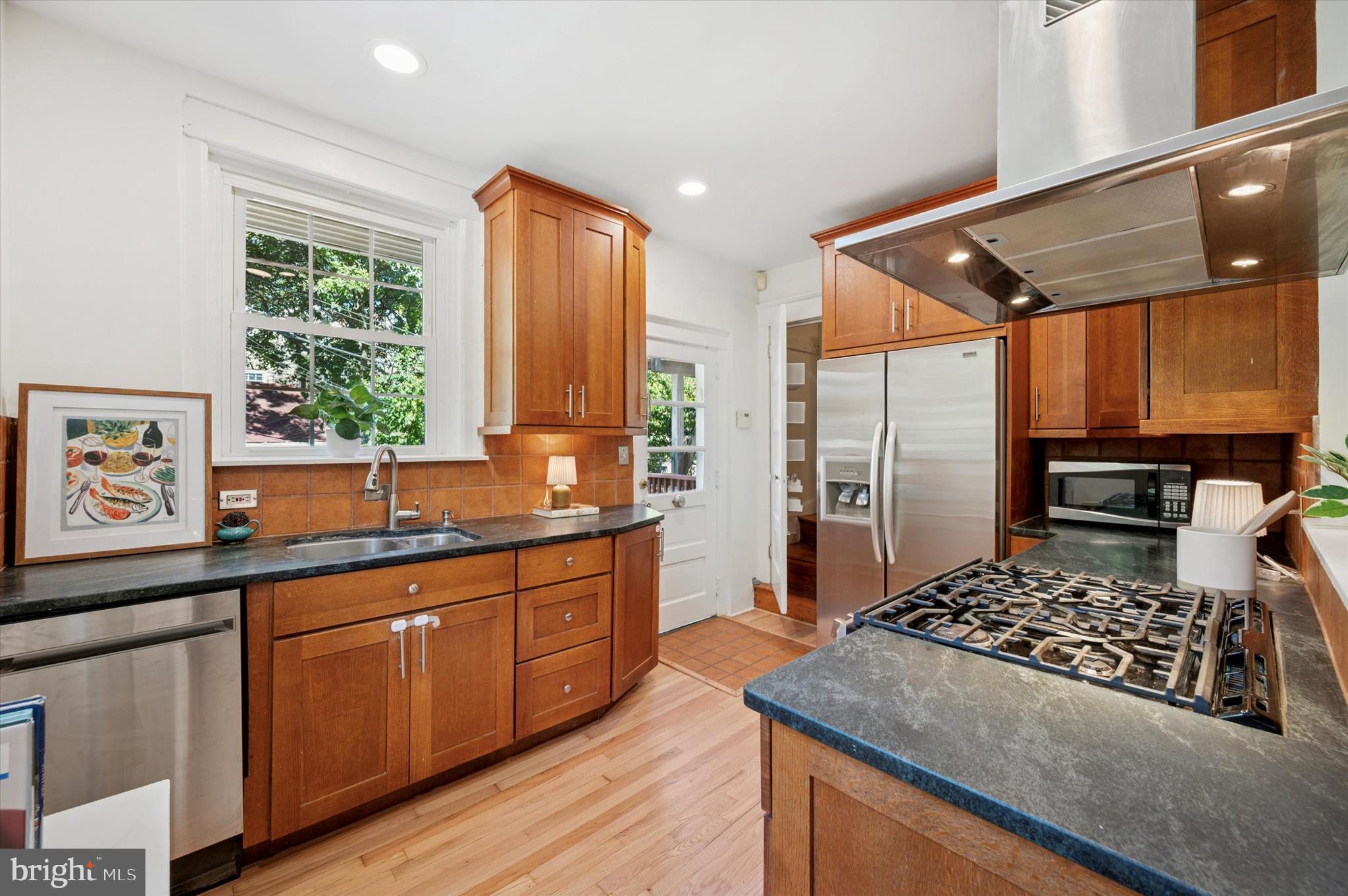525 Burnham Road Philadelphia, PA 19119 - Photo 11 of 36 a kitchen with stainless steel appliances granite countertop a stove a sink dishwasher and a refrigerator