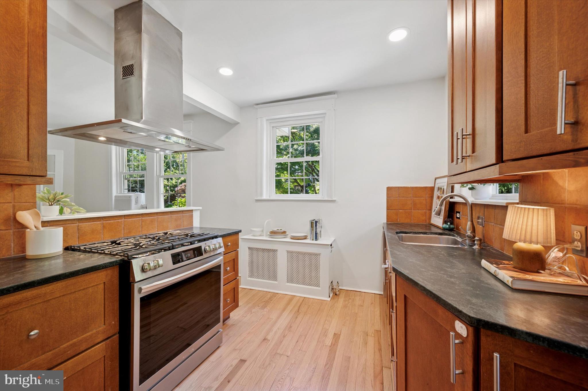 525 Burnham Road Philadelphia, PA 19119 - Photo 12 of 36 a kitchen with stainless steel appliances granite countertop a stove and a sink
