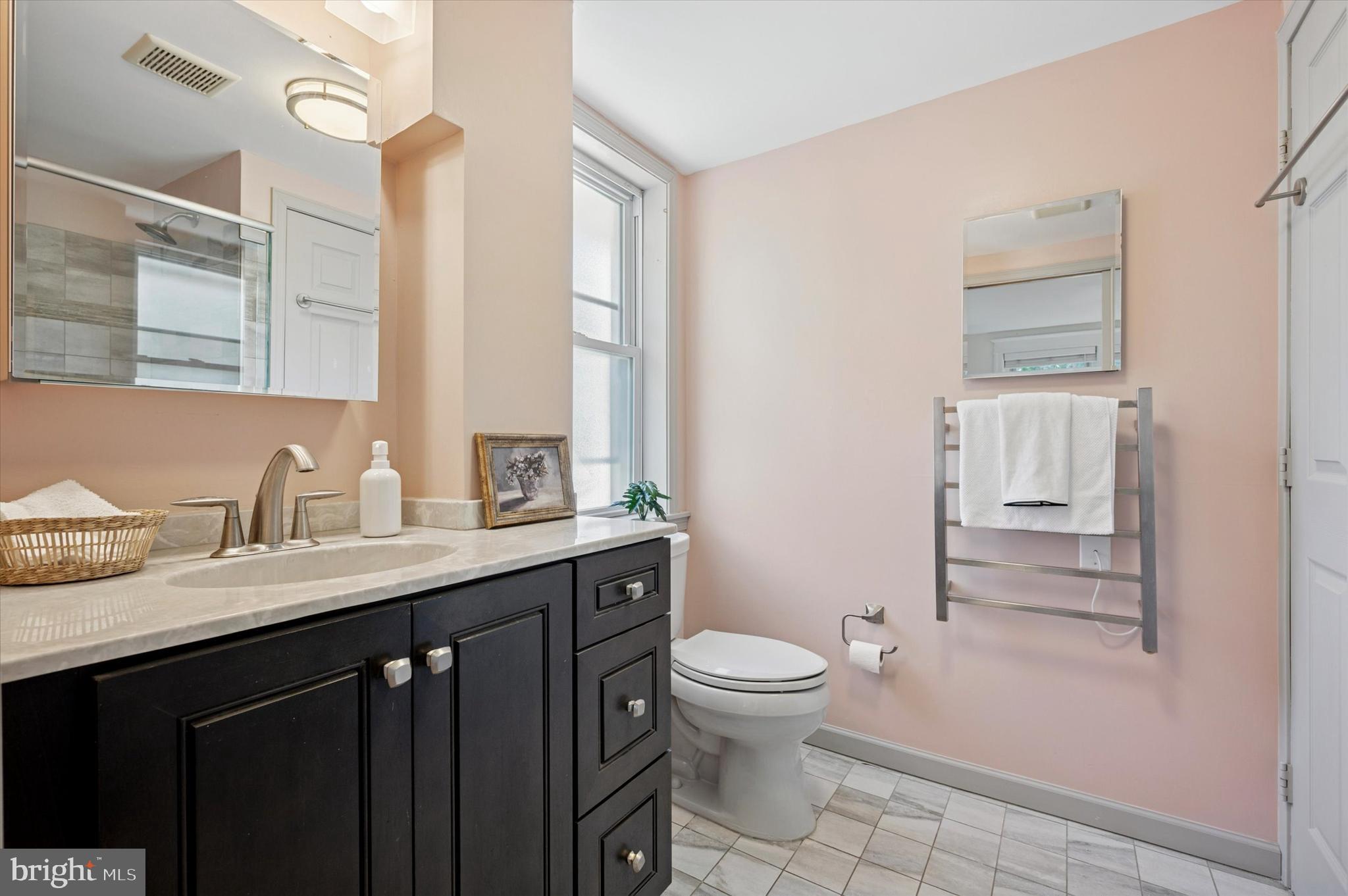 525 Burnham Road Philadelphia, PA 19119 - Photo 17 of 36 a bathroom with a granite countertop sink a toilet and a mirror