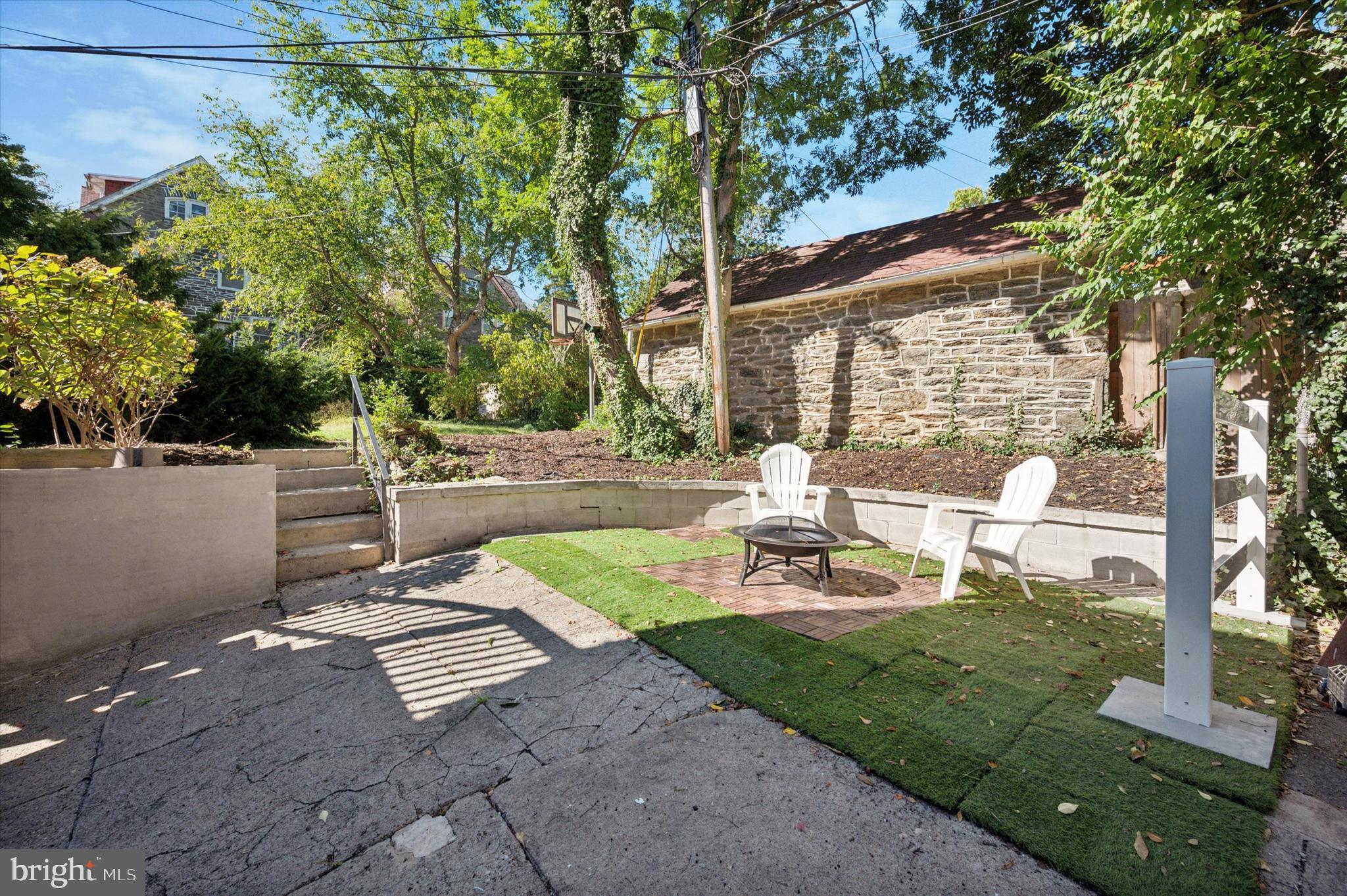525 Burnham Road Philadelphia, PA 19119 - Photo 30 of 36 a view of a backyard with sitting area