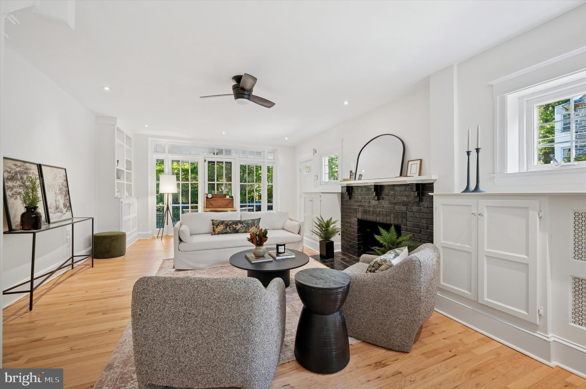 525 Burnham Road Philadelphia, PA 19119 - Photo 4 of 36 a living room with furniture a fireplace and a floor to ceiling window