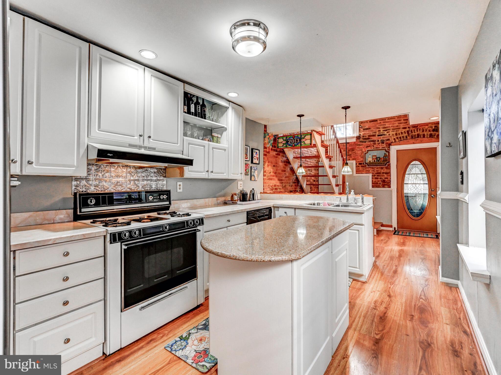 2013 Bank Street Baltimore, MD 21231 - Photo 11 of 38 a kitchen with stainless steel appliances granite countertop a stove and a sink