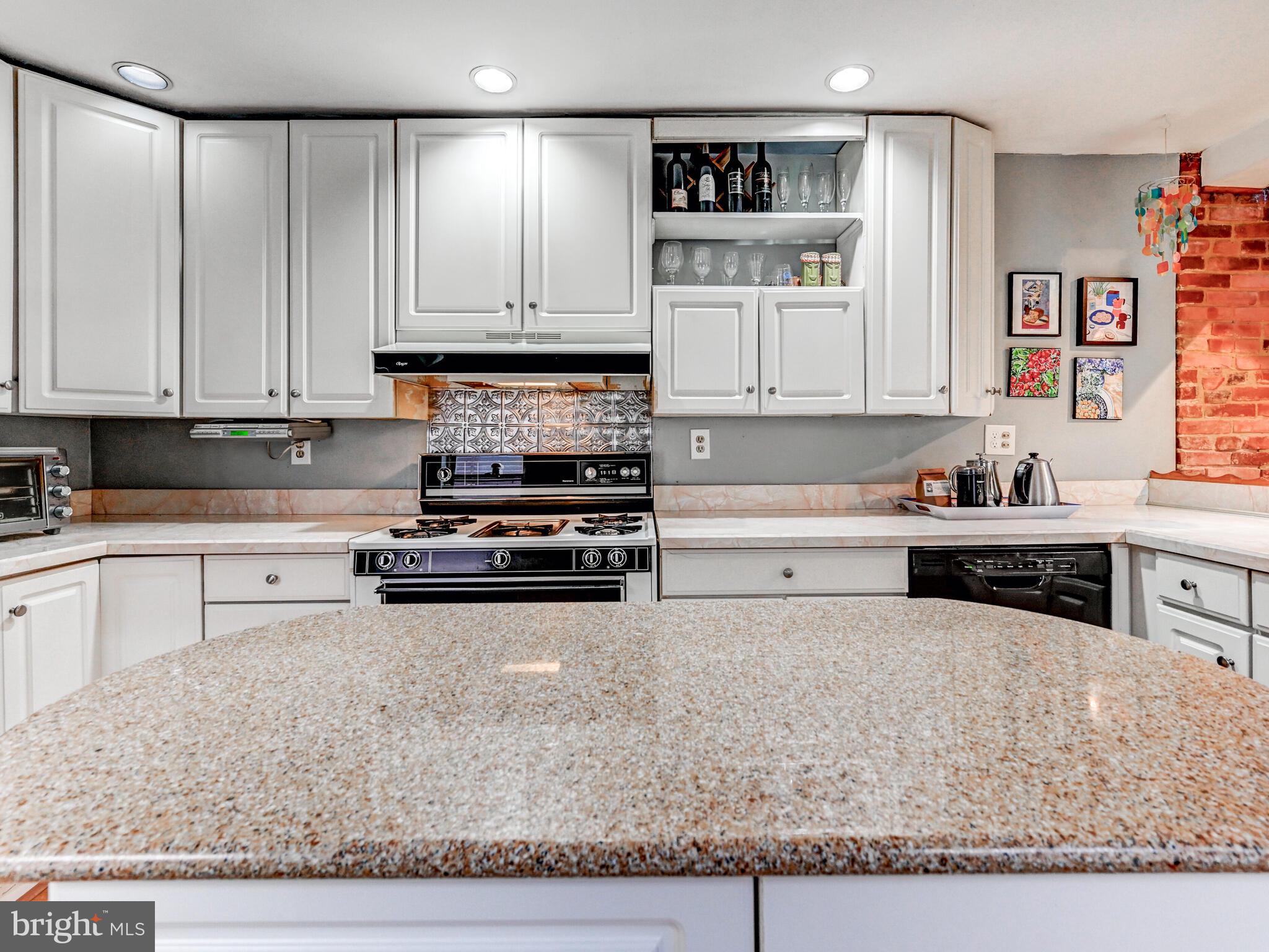 2013 Bank Street Baltimore, MD 21231 - Photo 14 of 38 a kitchen with stainless steel appliances granite countertop a refrigerator sink and cabinets