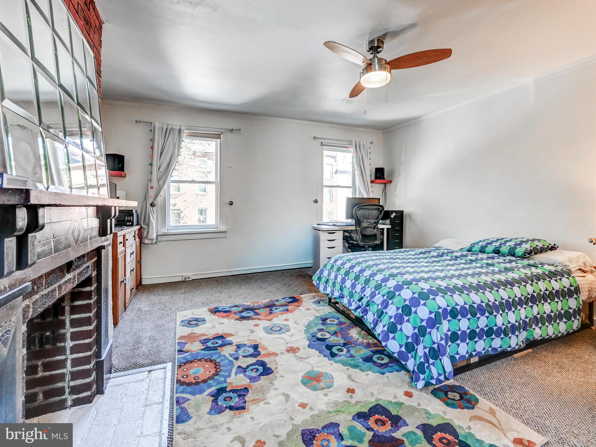2013 Bank Street Baltimore, MD 21231 - Photo 25 of 38 a bedroom with a bed and a chandelier