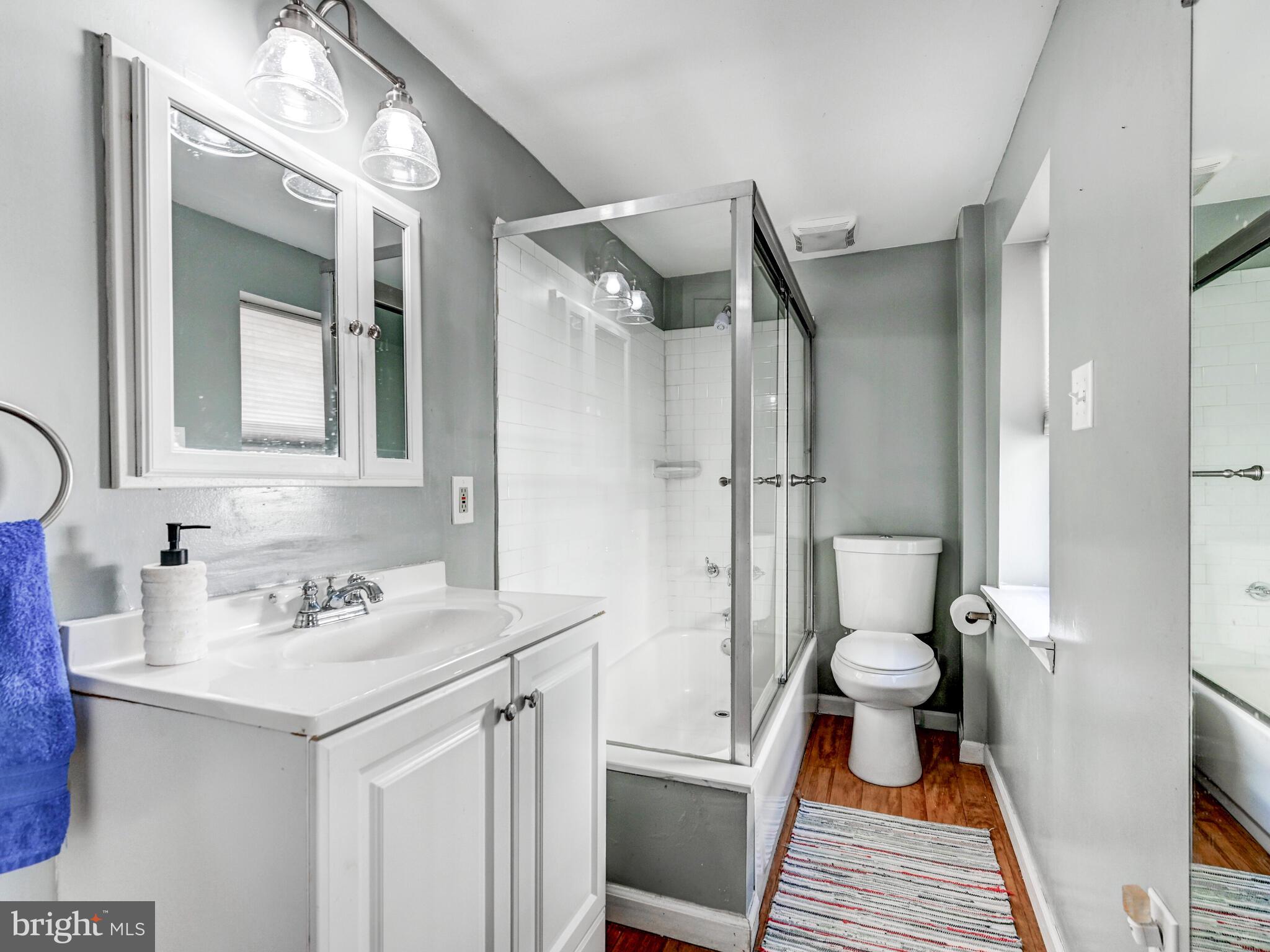 2013 Bank Street Baltimore, MD 21231 - Photo 26 of 38 a bathroom with a sink toilet a mirror and shower