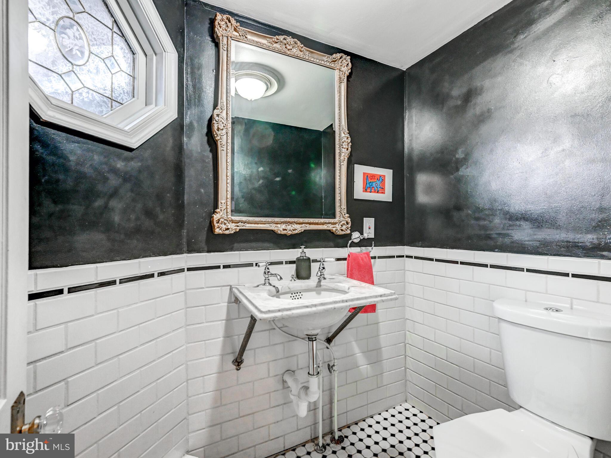 2013 Bank Street Baltimore, MD 21231 - Photo 31 of 38 a bathroom with a sink a toilet and shower