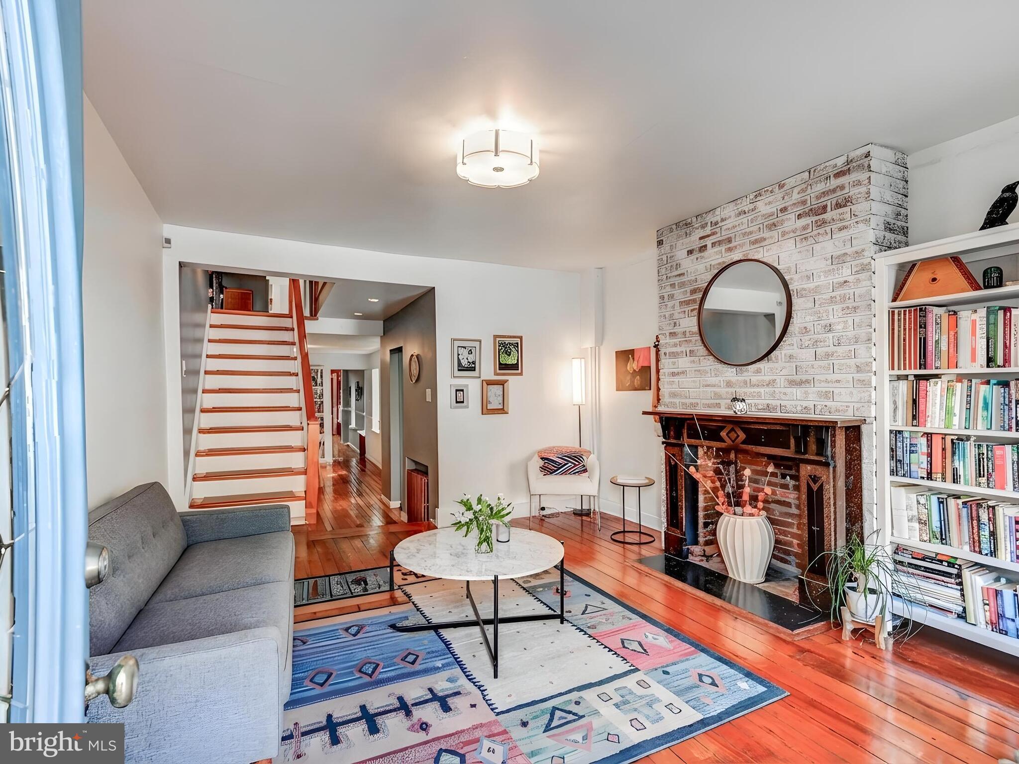 2013 Bank Street Baltimore, MD 21231 - Photo 5 of 38 a living room with furniture a fireplace and a book shelf