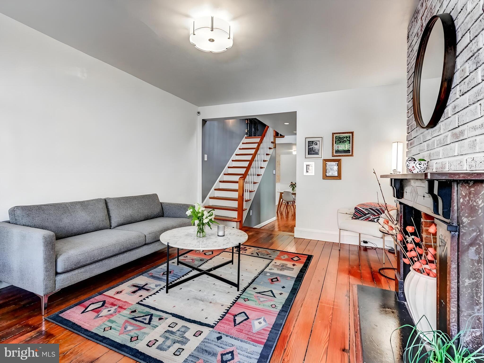 2013 Bank Street Baltimore, MD 21231 - Photo 6 of 38 a living room with furniture a rug and a chandelier