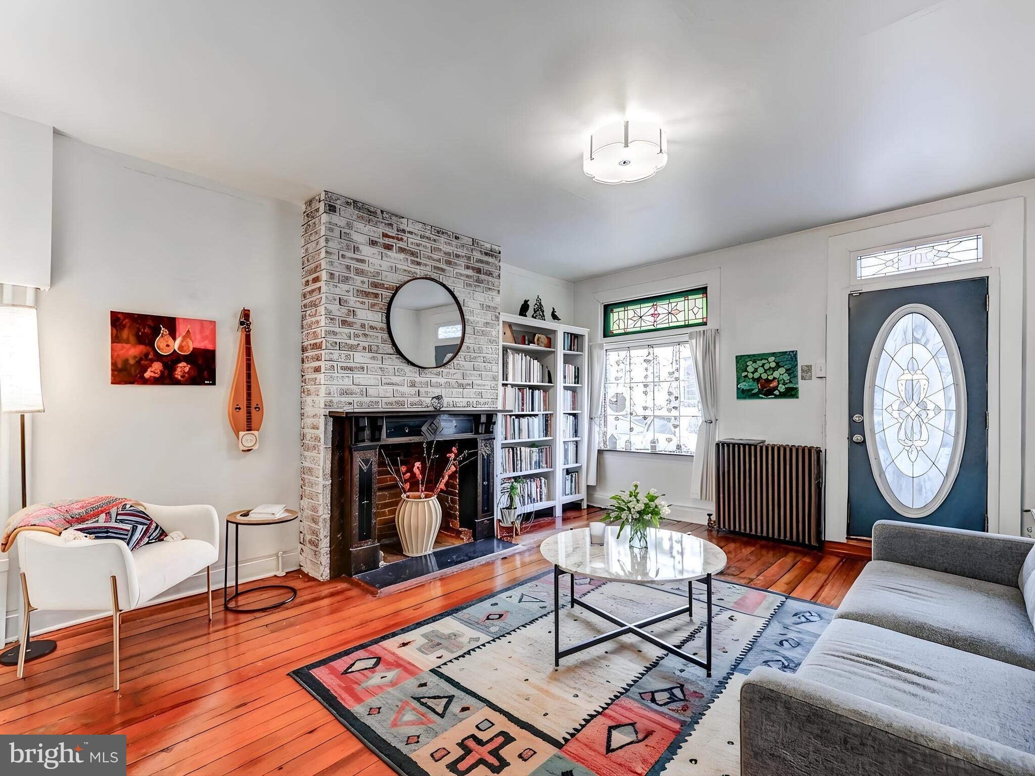 2013 Bank Street Baltimore, MD 21231 - Photo 7 of 38 a living room with furniture a clock and a fireplace