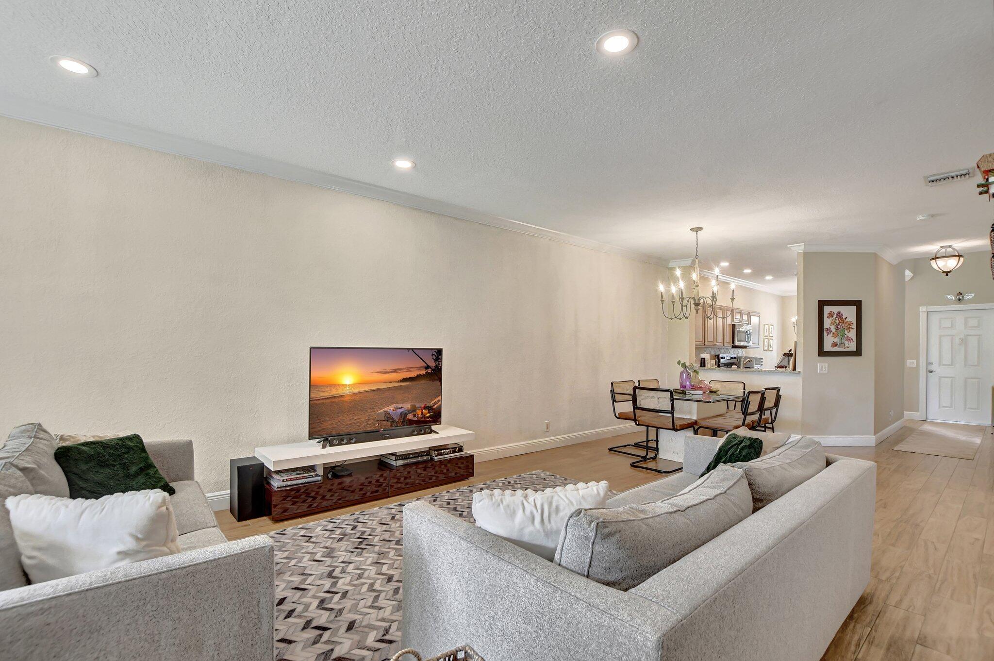 6682 Via Regina Boca Raton, FL 33433 - Photo 29 of 46 a living room with furniture and a flat screen tv
