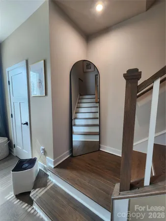 a view of entryway and hall with wooden floor