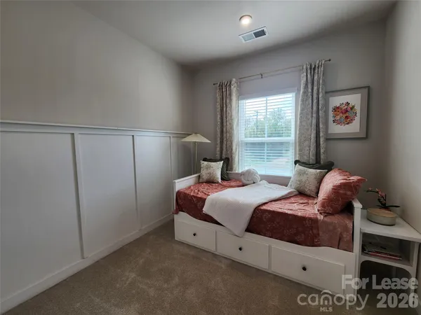 a bedroom with bed and a window