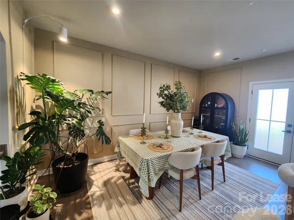 a dinning room with furniture and wooden floor