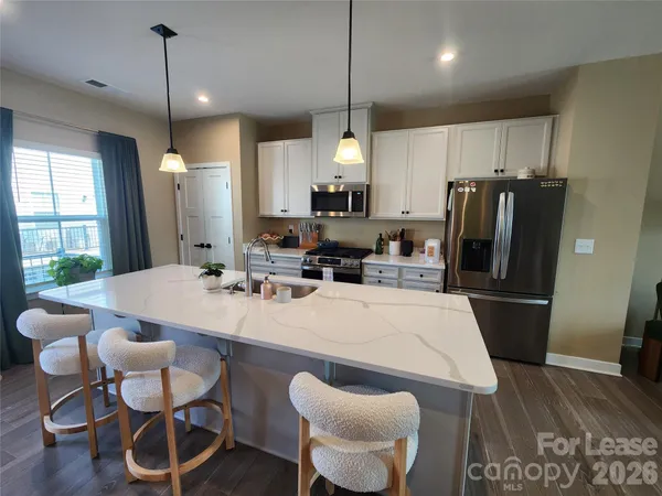 a large kitchen with a table and chairs