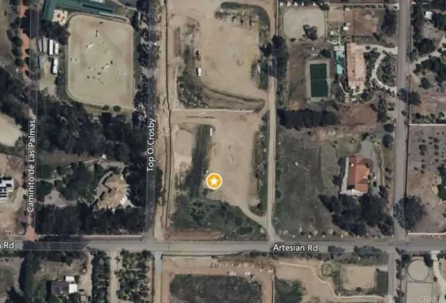 a view of a street with a big yard