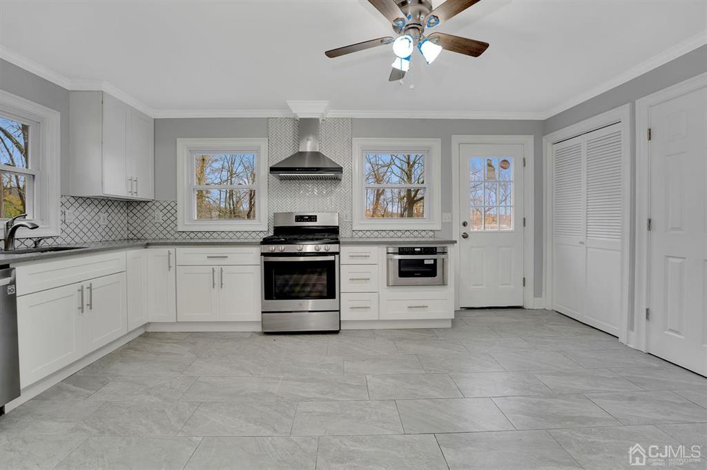 76 Old Road Princeton, NJ 08540 - Photo 13 of 33 a kitchen with stainless steel appliances a white stove top oven and cabinets