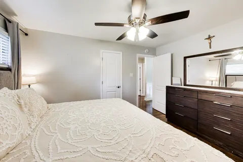 a bedroom with a large bed and a chandelier