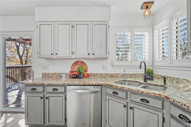 a kitchen with stainless steel appliances granite countertop a sink stove and cabinets