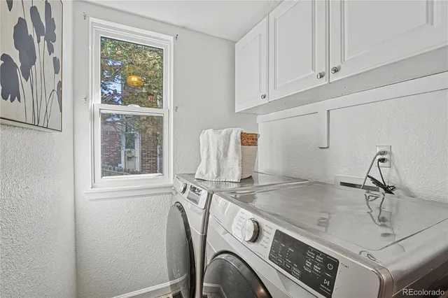 a utility room with a sink dryer and washer