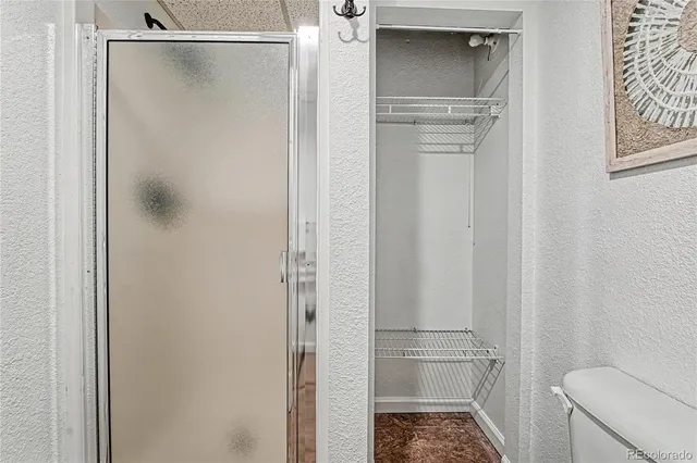 a bathroom with a glass shower door