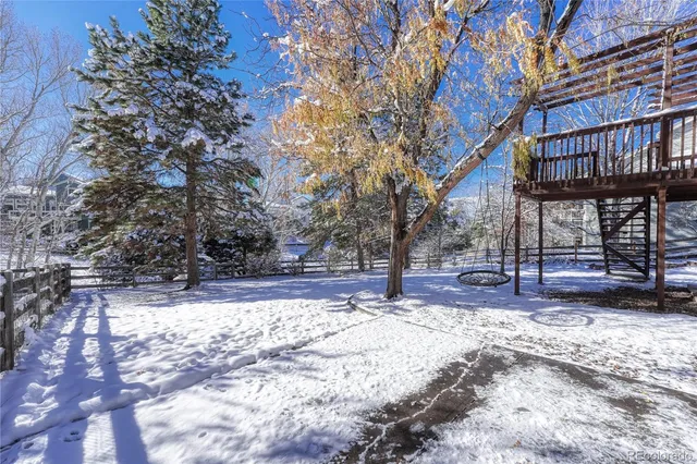 a view of a backyard with a large tree