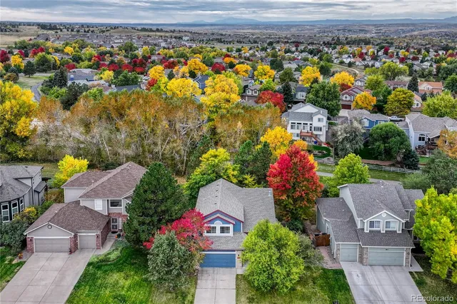 an aerial view of a house with a yard
