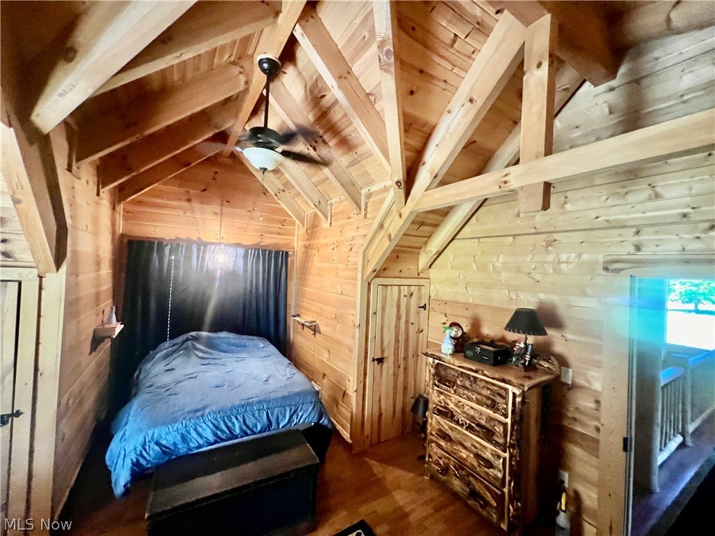 39589 National Road Bethesda, OH 43719 - Photo 14 of 35 Bedroom featuring vaulted ceiling with beams, wooden ceiling, dark hardwood / wood-style floors, wooden walls, and ceiling fan