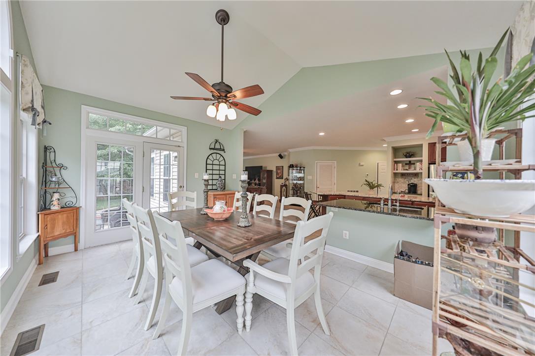 138 Clover Hollow Road Easton, PA 18045 - Photo 26 of 95 Natural light floods this dining area, featuring a vaulted ceiling and direct outdoor access.