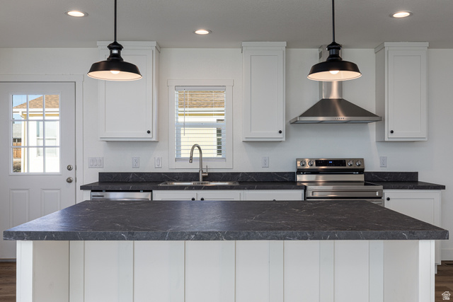 749 Riddle Drive Fredonia, AZ 86022 - Photo 2 of 41 Kitchen with white cabinets, dark wood finished floors, stainless steel range with electric stovetop, a kitchen island, and pendant lighting