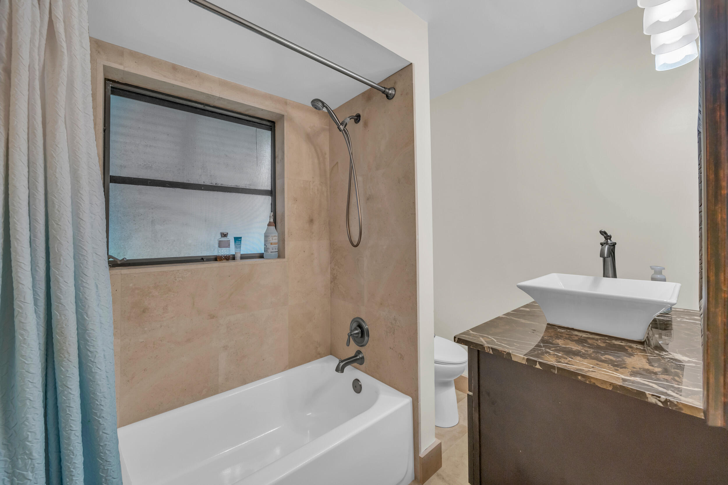 1305 Peninsular Road Jupiter, FL 33469 - Photo 26 of 46 a bathroom with a granite countertop sink toilet and shower