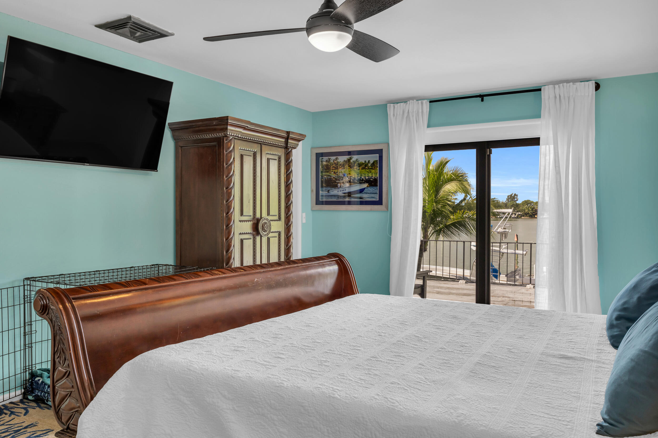 1305 Peninsular Road Jupiter, FL 33469 - Photo 29 of 46 a bedroom with a bed and a flat screen tv