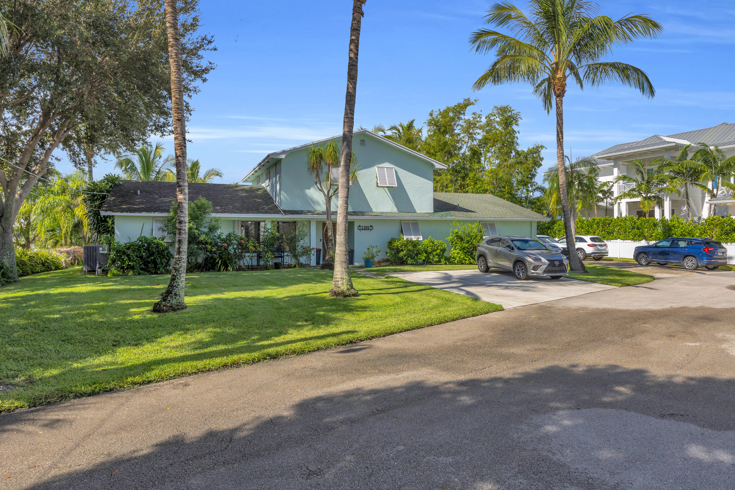 1305 Peninsular Road Jupiter, FL 33469 - Photo 3 of 46 a view of a parked cars in front of a house