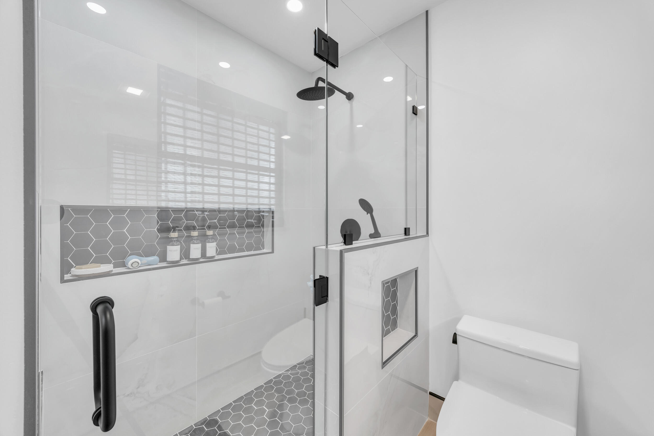 1305 Peninsular Road Jupiter, FL 33469 - Photo 32 of 46 a bathroom with a toilet a sink and mirror