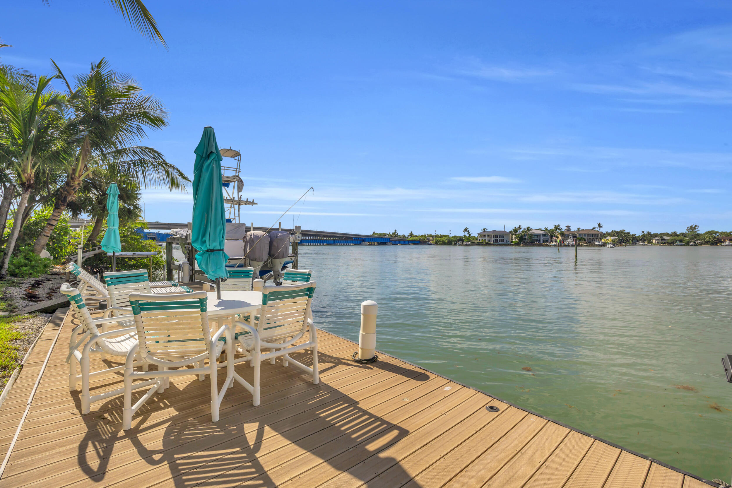 1305 Peninsular Road Jupiter, FL 33469 - Photo 39 of 46 a view of a lake with a table and chairs