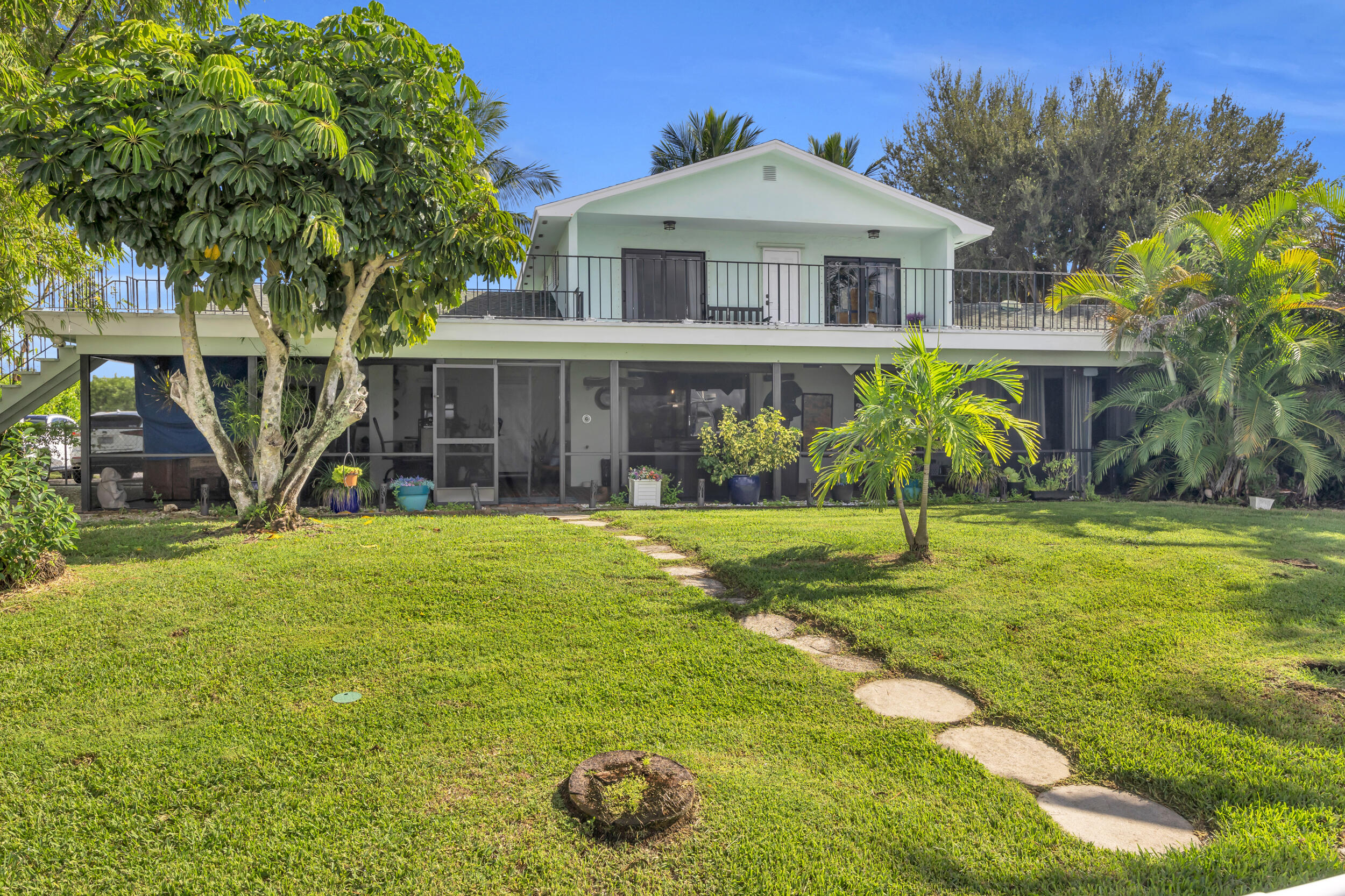 1305 Peninsular Road Jupiter, FL 33469 - Photo 4 of 46 a front view of a house with garden