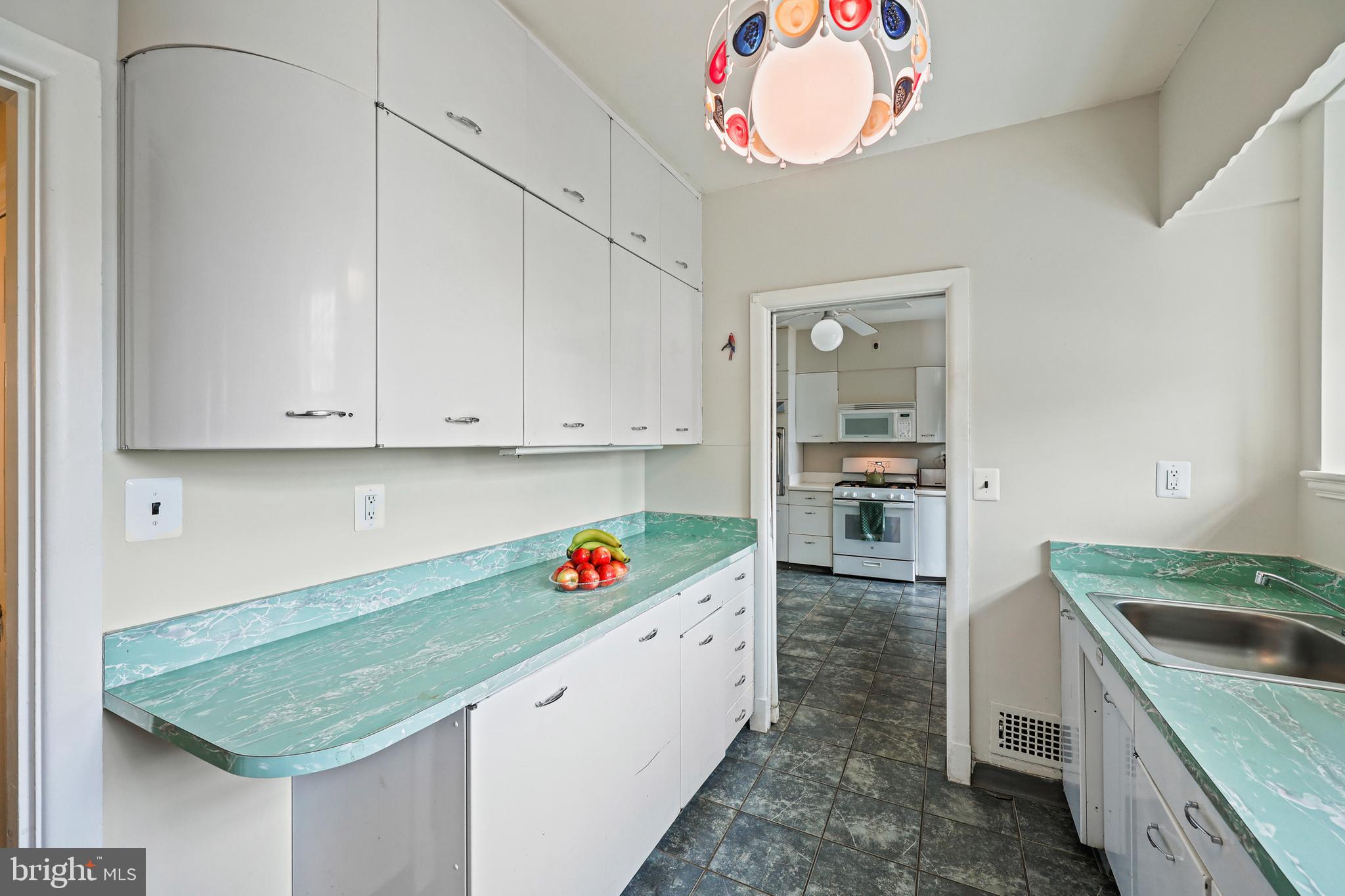 119 St Dunstans Road Baltimore, MD 21212 - Photo 13 of 54 a kitchen with granite countertop white cabinets and appliances