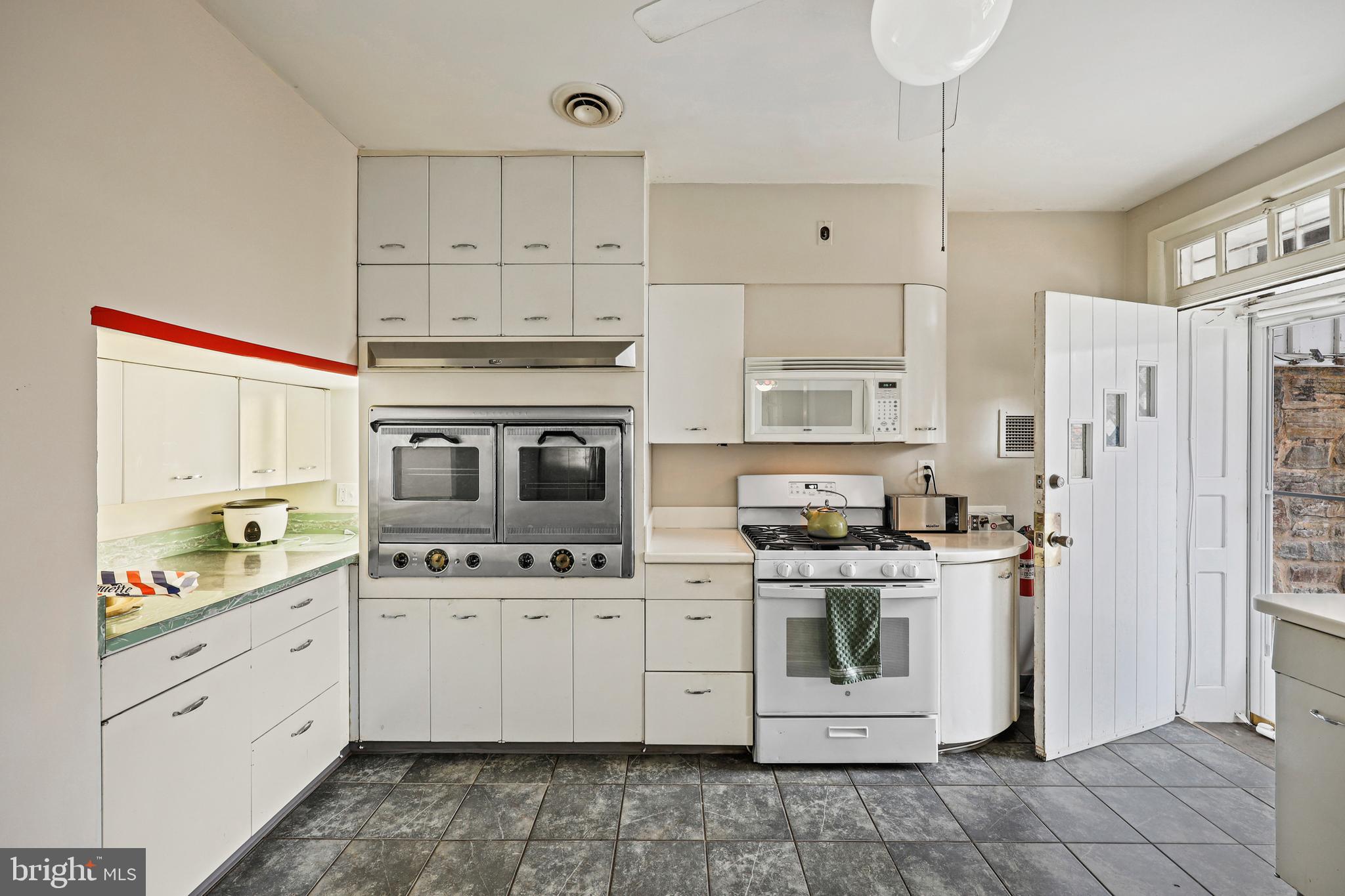 119 St Dunstans Road Baltimore, MD 21212 - Photo 14 of 54 a kitchen with stainless steel appliances granite countertop a stove a sink and a refrigerator