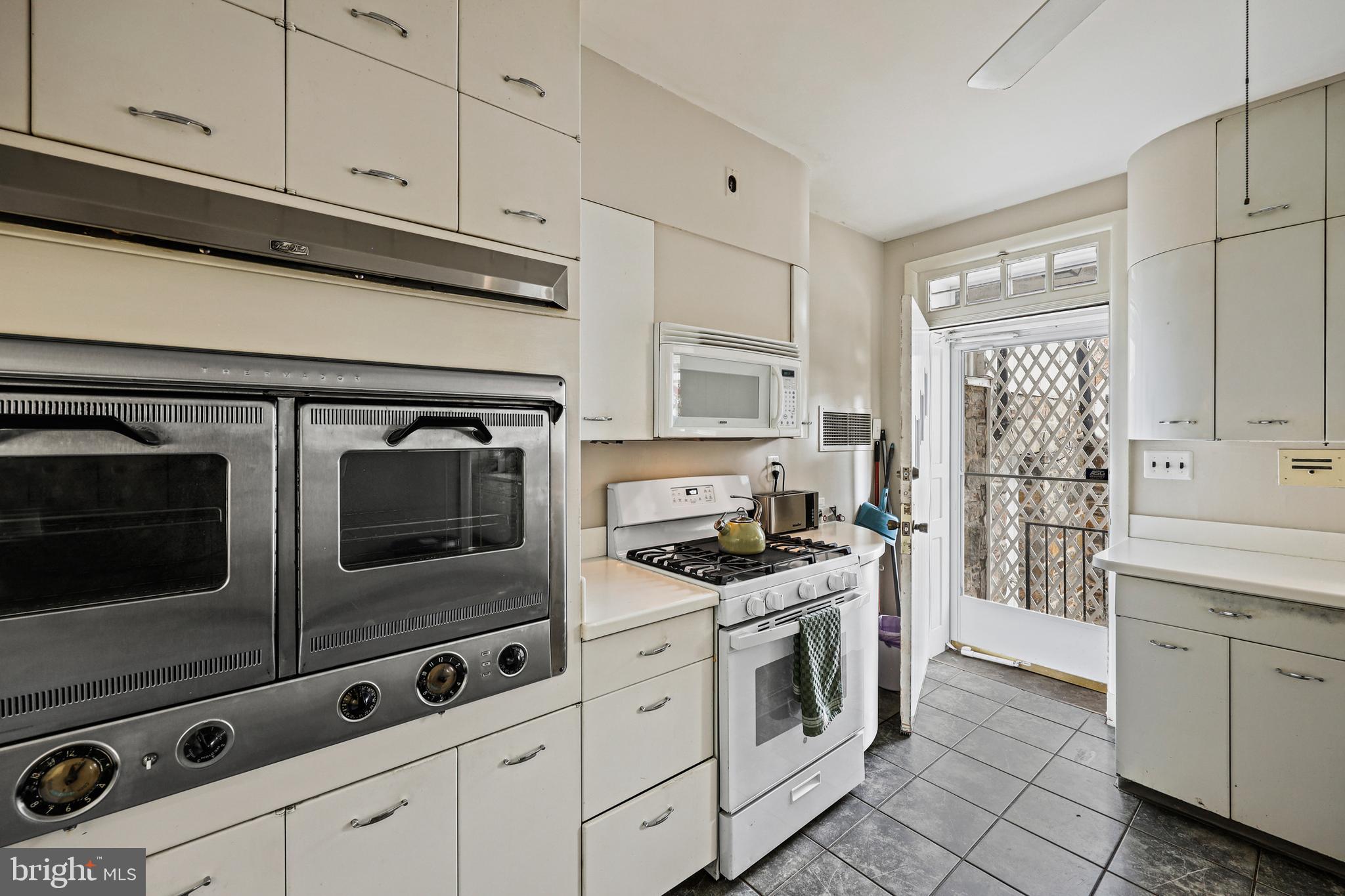 119 St Dunstans Road Baltimore, MD 21212 - Photo 16 of 54 a kitchen with stainless steel appliances white cabinets and stove
