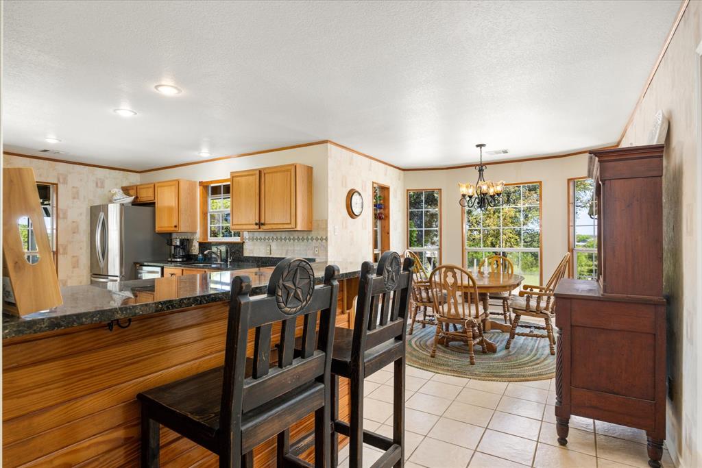 1311 Williamson Road Granbury, TX 76048 - Photo 21 of 40 a view of a dining room with furniture window and outside view