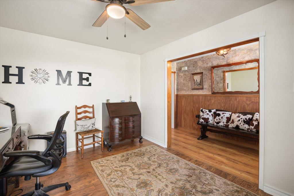 1311 Williamson Road Granbury, TX 76048 - Photo 23 of 40 a bedroom with furniture and a wooden floor