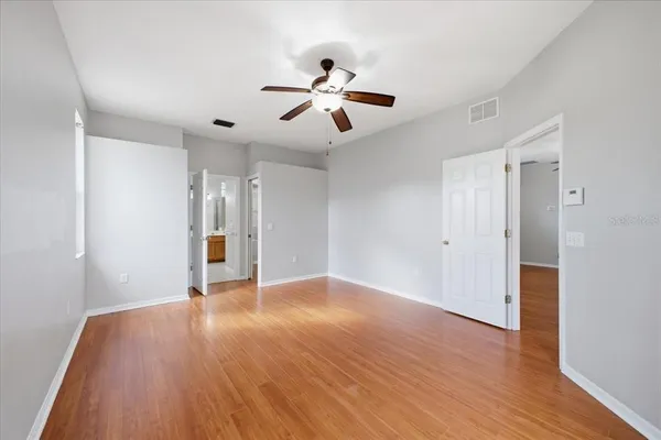 a view of an empty room with wooden floor