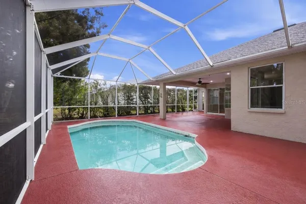 a view of a backyard with a swimming pool