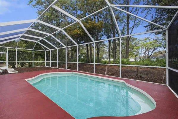 a view of a backyard with a swimming pool