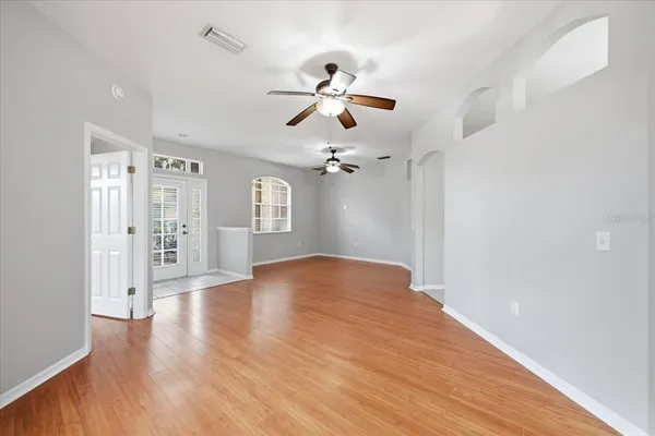 wooden floor in an empty room with a window