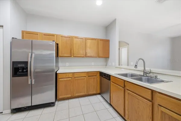 a kitchen with stainless steel appliances granite countertop a refrigerator and a sink