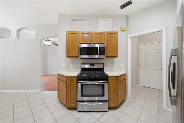 a kitchen with granite countertop a stove and a refrigerator