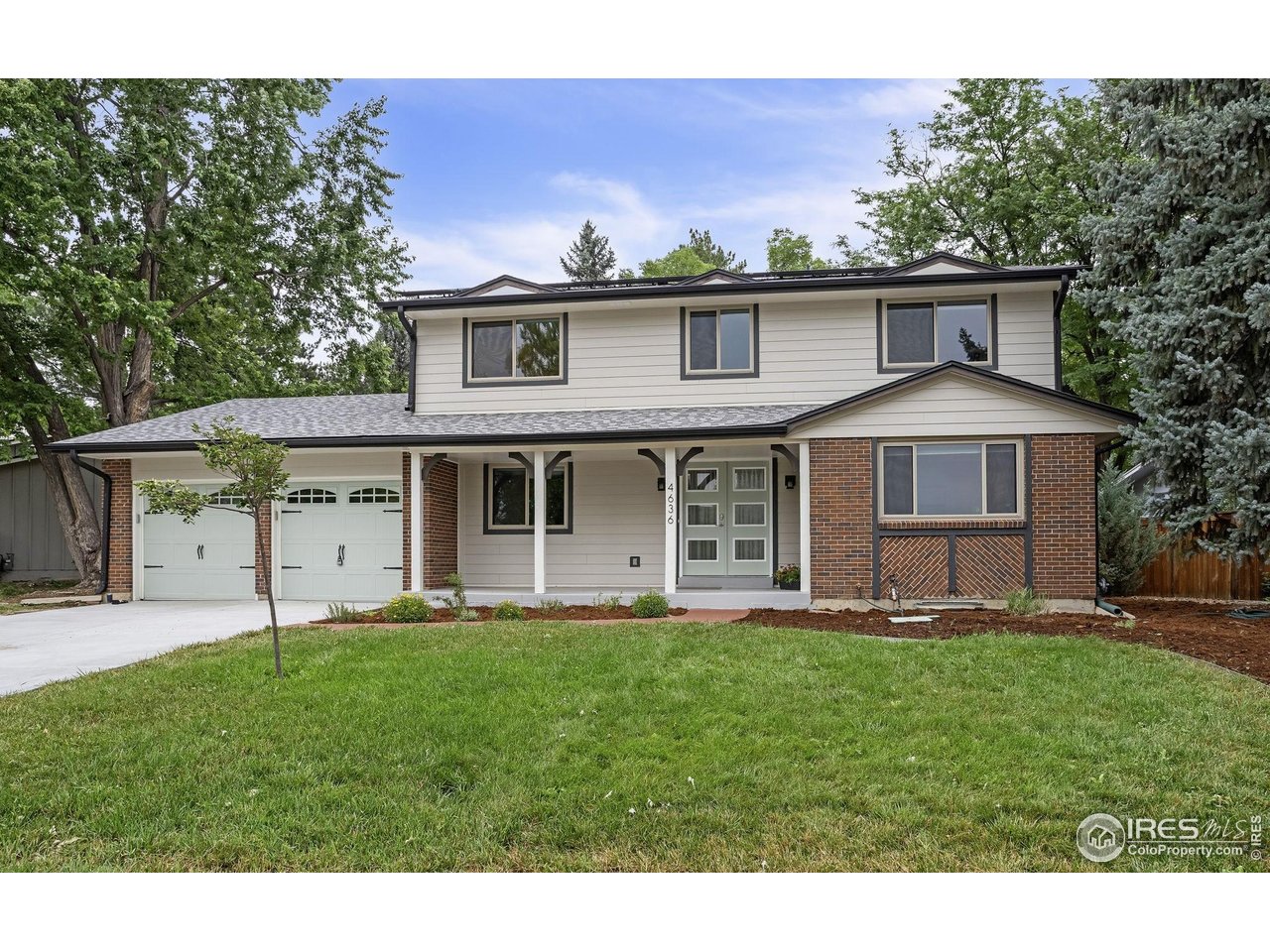 4636 Devonshire Street Boulder, CO 80301 - Photo 1 of 40 a front view of a house with a yard and garage