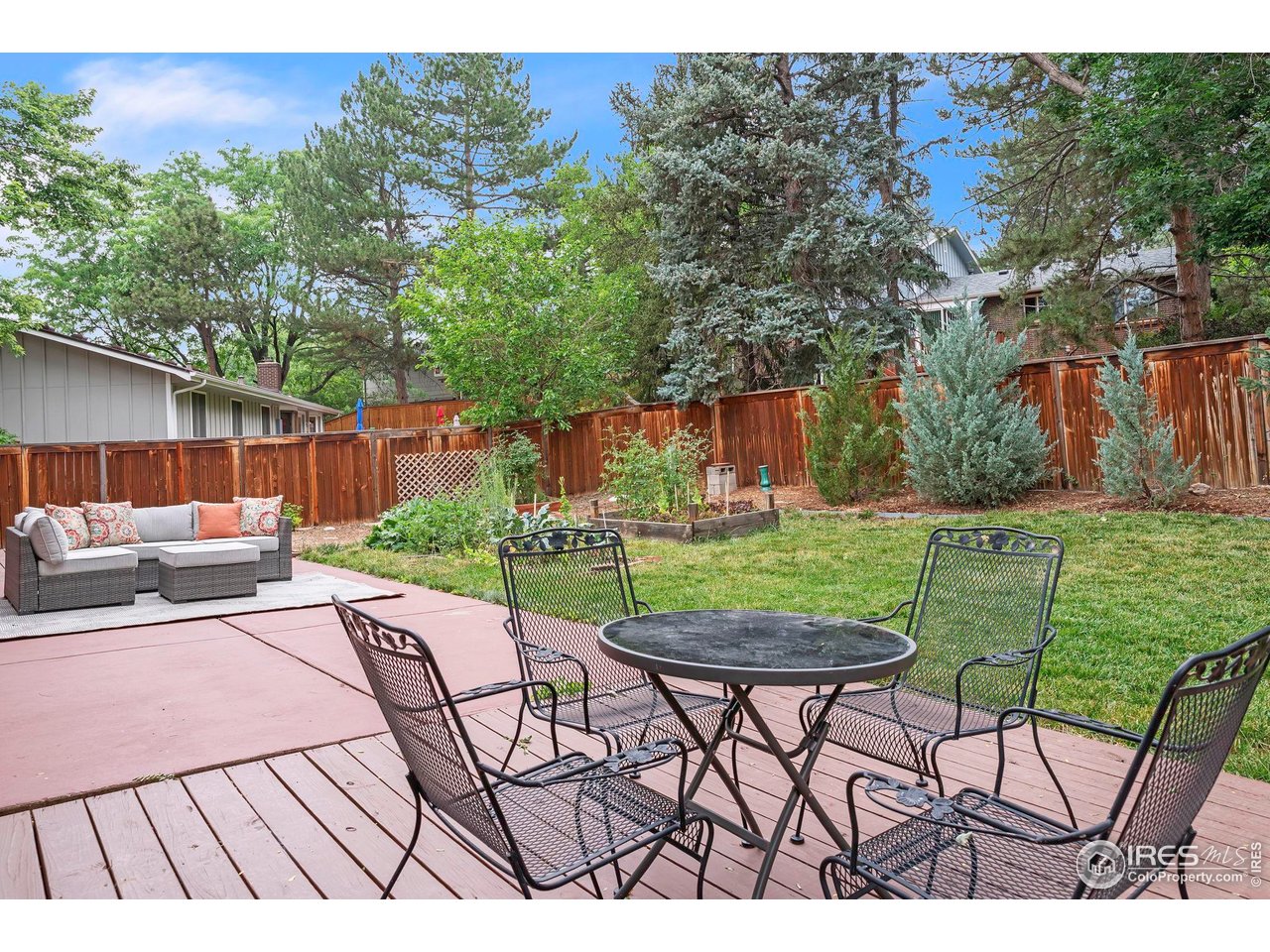 4636 Devonshire Street Boulder, CO 80301 - Photo 11 of 40 a view of a patio with table and chairs with wooden fence and plants