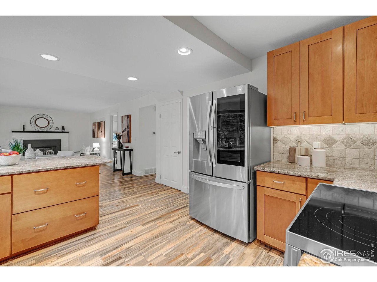 4636 Devonshire Street Boulder, CO 80301 - Photo 15 of 40 a kitchen with granite countertop a refrigerator and a stove top oven